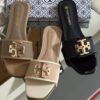 Buy Tory Burch flat slippers for women in Pakistan. Sizes 36–42 available. Premium packaging with brand box. Price Rs. 3200. Shop online at Shop2Door now!